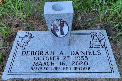 individual engraved granite headstone with praying hands and cross and praying angel and portrait